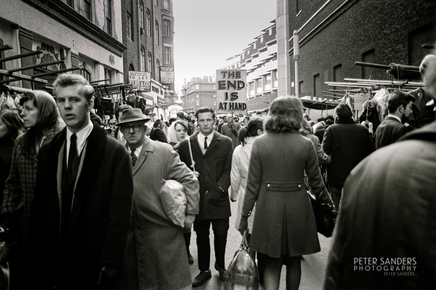 Peter Sanders - Peter Sanders Peter Sander Photos - a crowd of people walking down a street